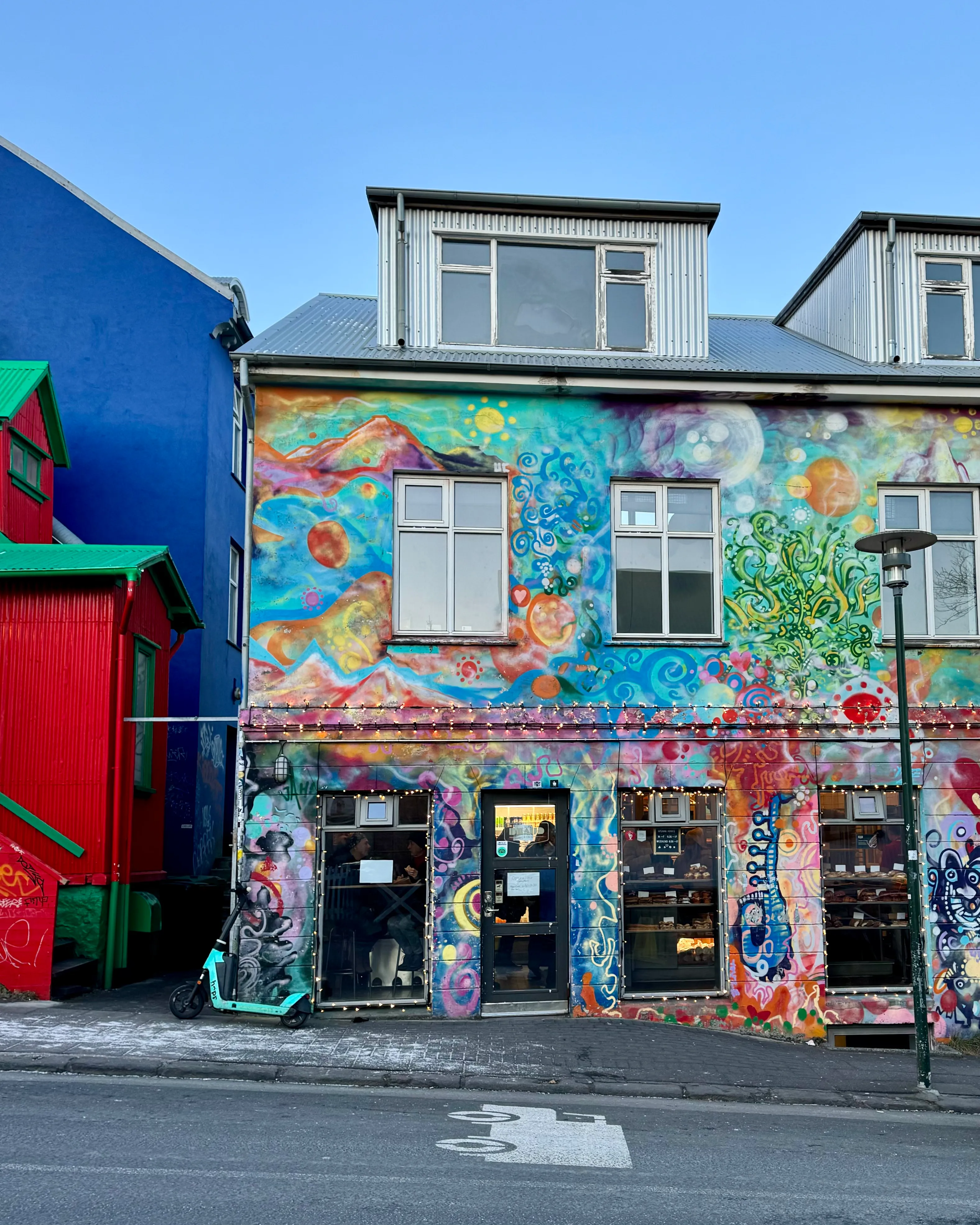 A bakery in a building with a colorful mural