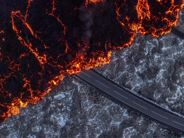 Lava flows over a road