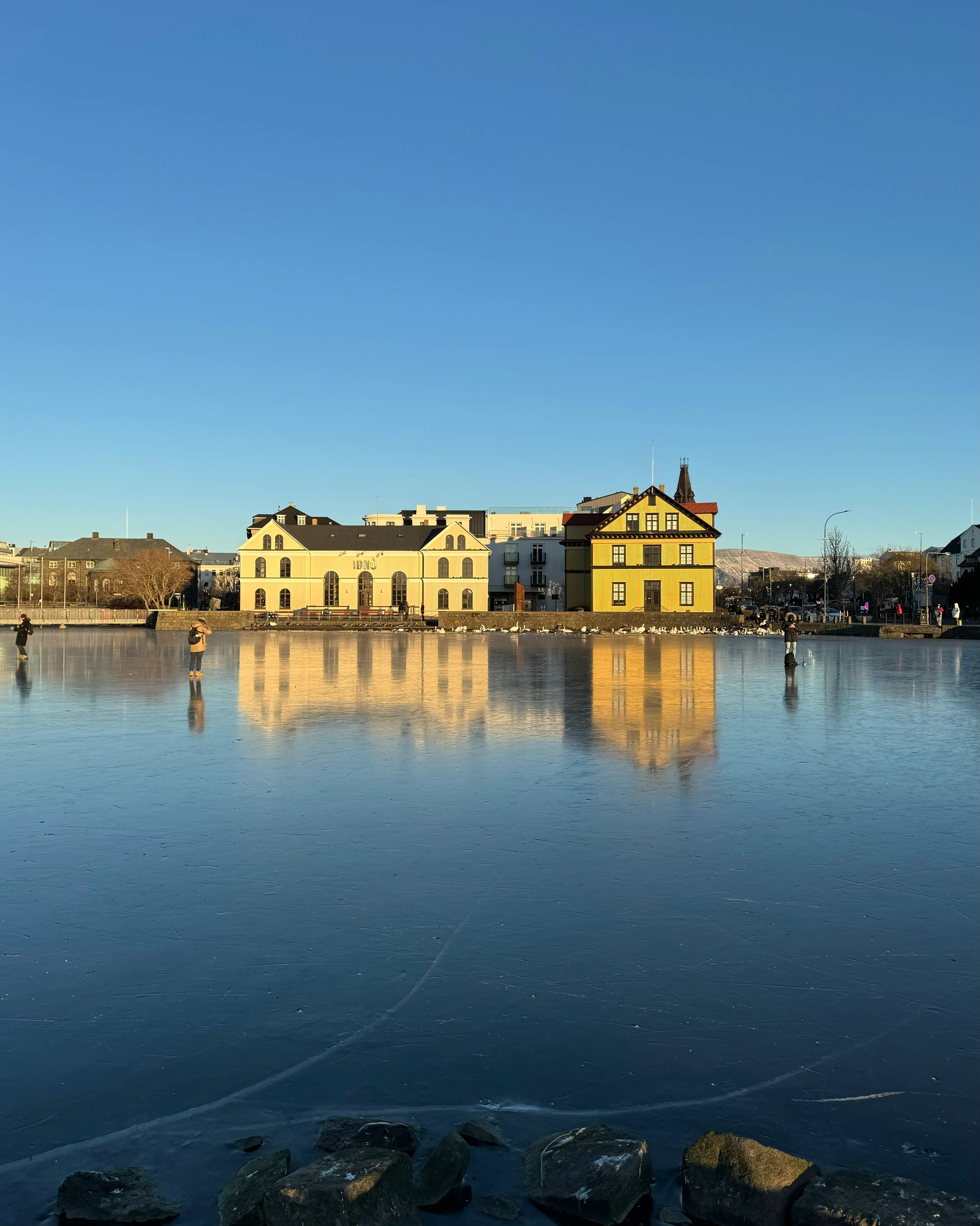 A building reflecting on a frozen lake