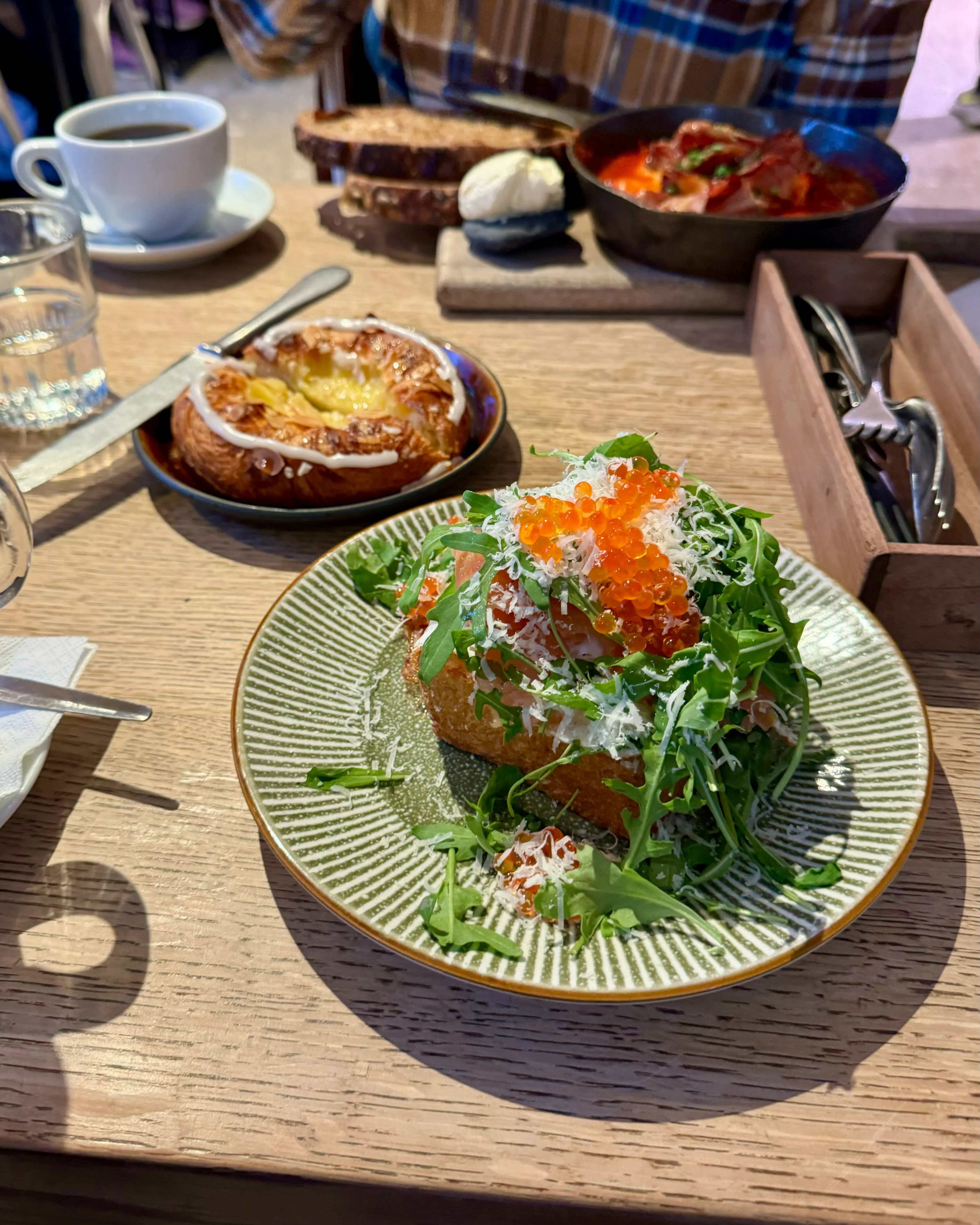 A piece of salmon roast topped with roe and arugula